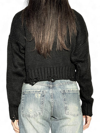 Pull cropped nero a collo alto con rotture sul fondo